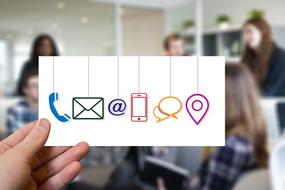 card with communication icons in front of people in Office