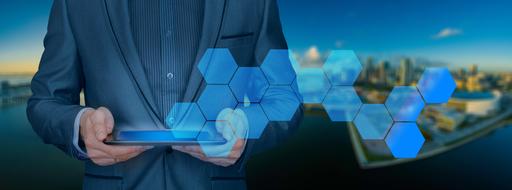 businessman with tablet and blue honeycomb