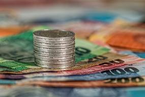 Coins and colorful banknotes