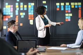 African American woman at black board in office