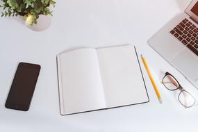 smartphone, notepad, pencil, glasses and laptop