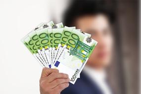 euro bills in hand of caucasian man