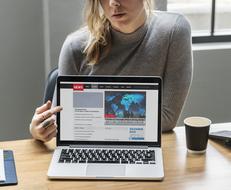 caucasian girl pionting on display of laptop computer
