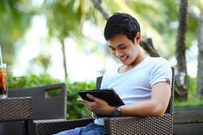 Man is sitting with the tablet