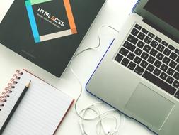 laptop and notebook on a desk