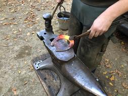 blacksmith forges a horseshoe