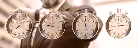 businessman looking at wrest watches behind four stopwatches