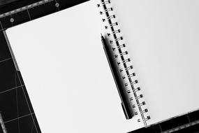 Black pen on the white notebook