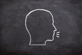 drawn talking head on a blackboard