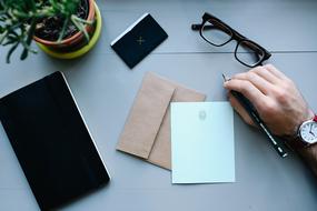 manâs hand and notebook