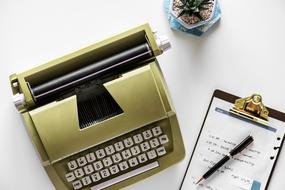 typewriter and notebook on desk in office
