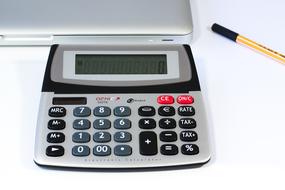 Calculator,pen and laptop