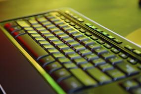 green light over black keyboard