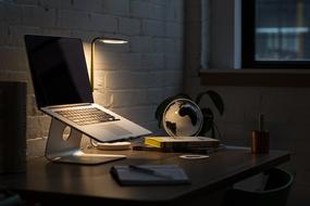 Apple Computer on the desktop in the dark