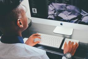 young man working on an apple computer