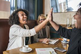 happy people holding hands in office