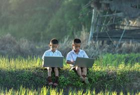 two boys with laptops outdoor