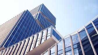 Bottom view of the beautiful glass building at blue sky background in Amsterdam, Netherlands