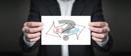 Man with "Lies or truth" sign clipart