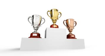 Colorful, shiny metal cups on the white podium, at white background, clipart