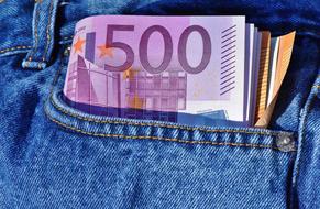 Colorful Euro banknotes in the pocket of the blue jeans, on the close-up