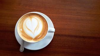 a cup of frothy coffee on the table