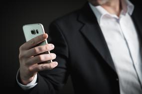 businessman holding smartphone