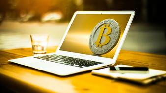 bitcoin symbol on laptop monitor