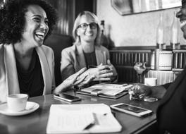 smiling Afro Americans and caucasian man at Meeting