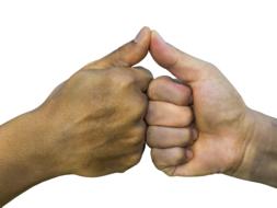 Putting fists and thumbs together in agreement, at white background