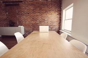 empty meeting table with the brick wall behind