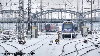 Beautiful railway station with colorful trains, in snow, in the winter, in Munich, Germany