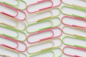 multicolored paper clips are folded on the table