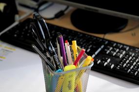 colorful Office supplies and keyboard on desk