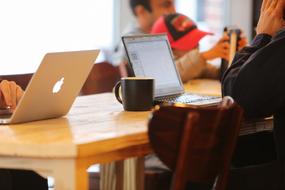 managers with laptops in a cafe