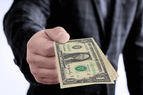 dollar bills in the hands of a man