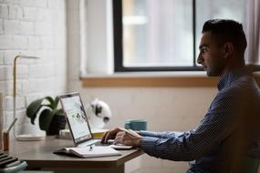 man programming at laptop