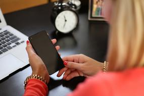 Mobile Phone with empty screen in female hands