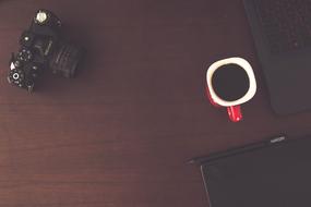 red cup with coffee on the office table