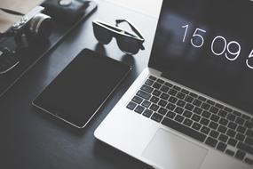 camera, Macbook and glasses on desk