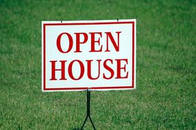 sign open house on a green lawn