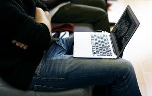 laptop on the legs of a man