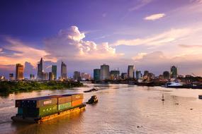ship on the river with skyscrapers on the banks