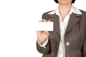 white business card in the hand of a business woman
