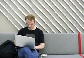 young man working on laptop on the couch