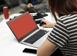 Woman, in the white and black, striped t-shirt, using laptop, with the mouse