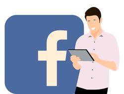 man with digital device at facebook application icon