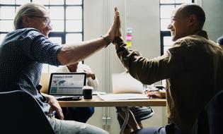 Agreement, two men holding hands together in office