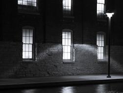 black and white photo of a street lamp and building facade