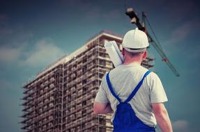 builder in front of the house that is being built